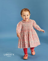 toddler in hand-smocked dress made from Liberty fabric