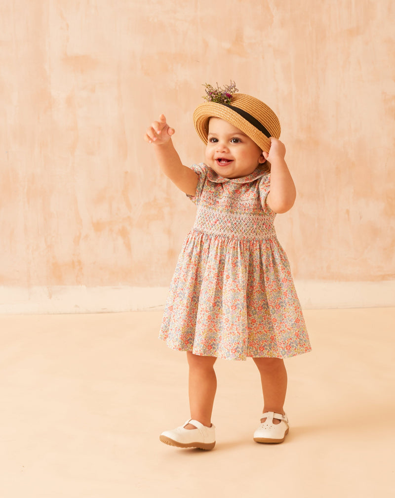 Baby wearing Liberty print floral dress