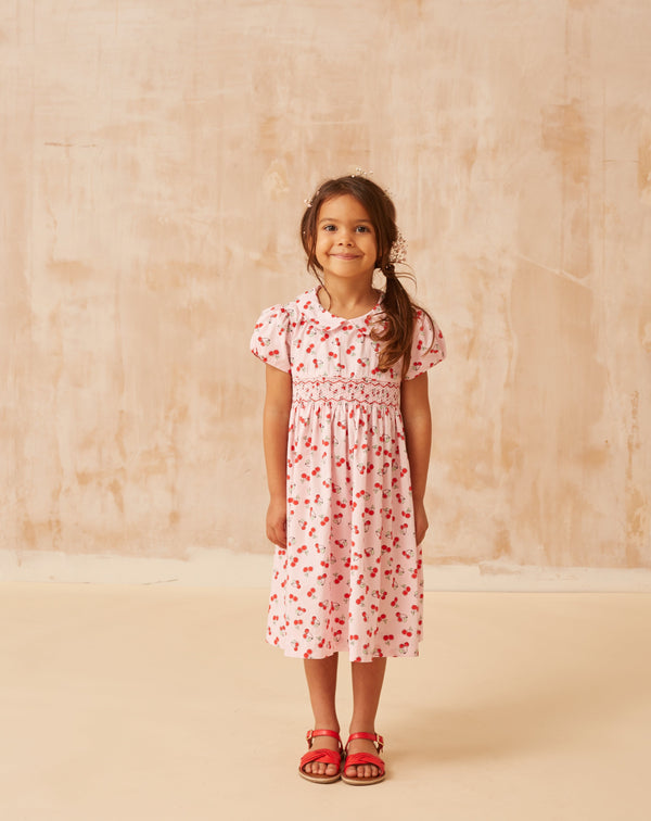 girl in cherry print dress