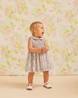 Baby in sleeveless smocked dress