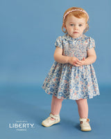 hand-smocked dress made from Liberty fabric worn by toddler girl