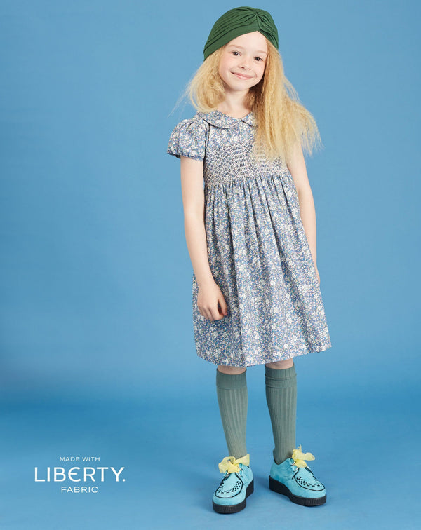 girl in Liberty print smocked dress