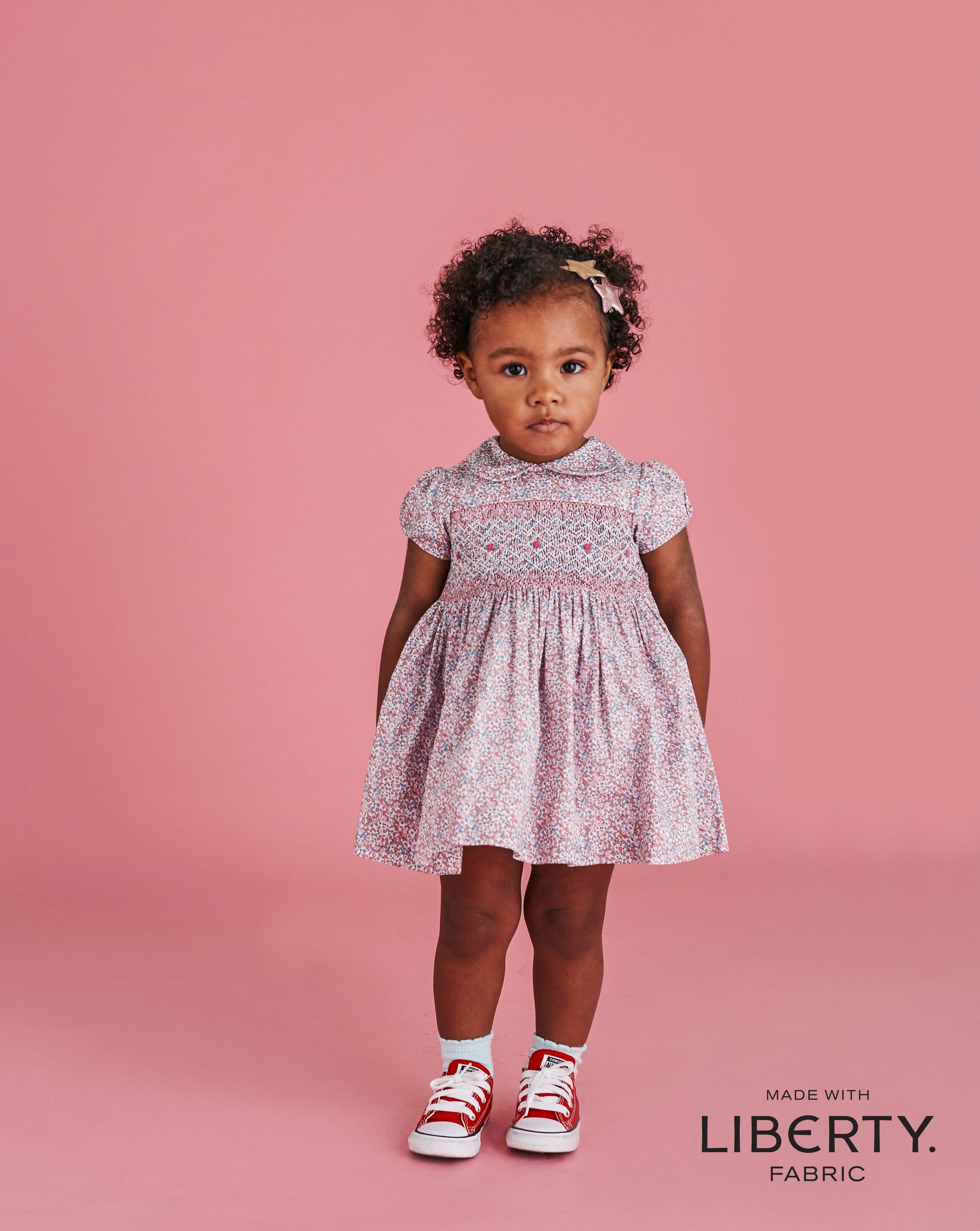 toddler in smocked dress made with Liberty fabric