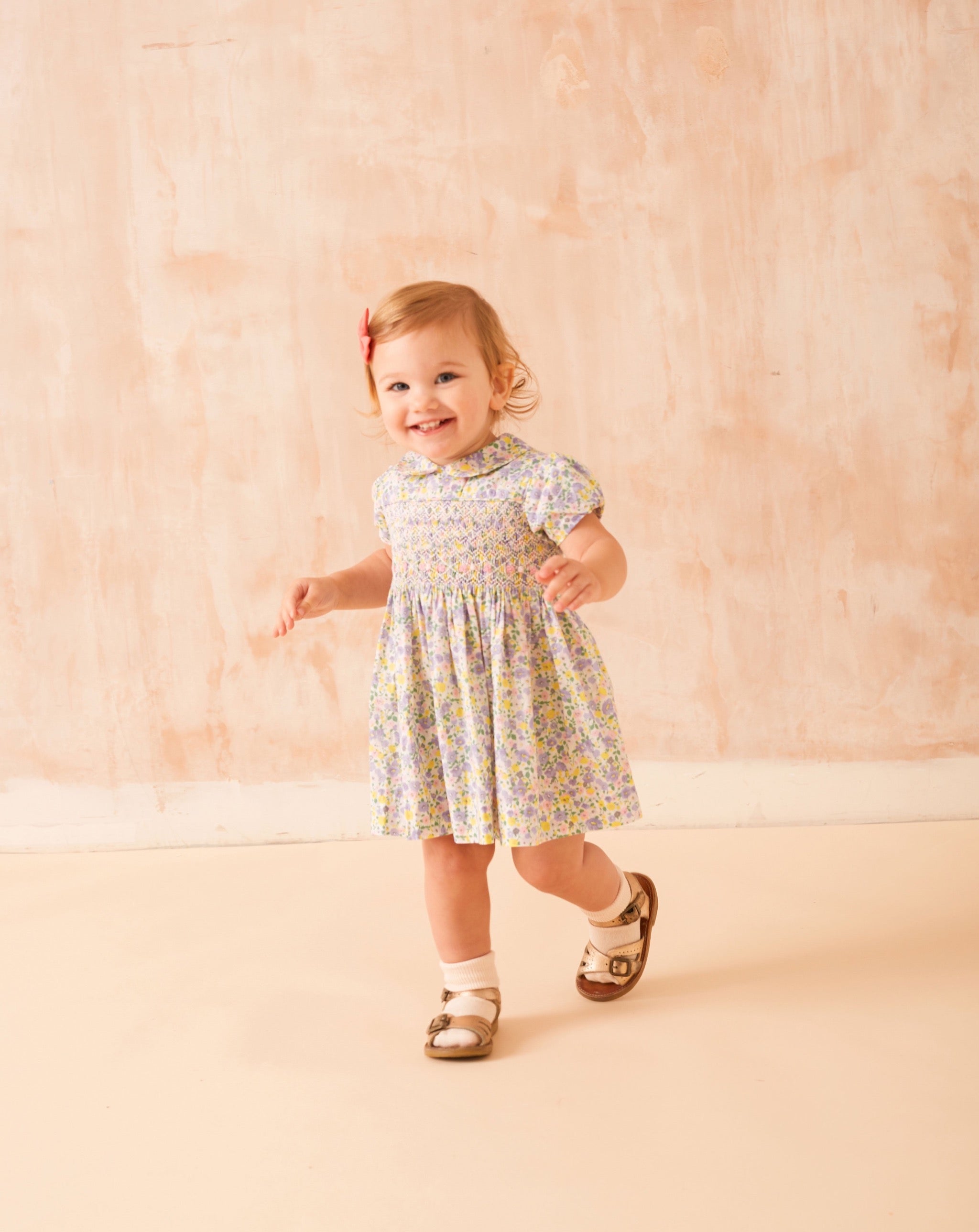 toddler in floral hand-smocked dress