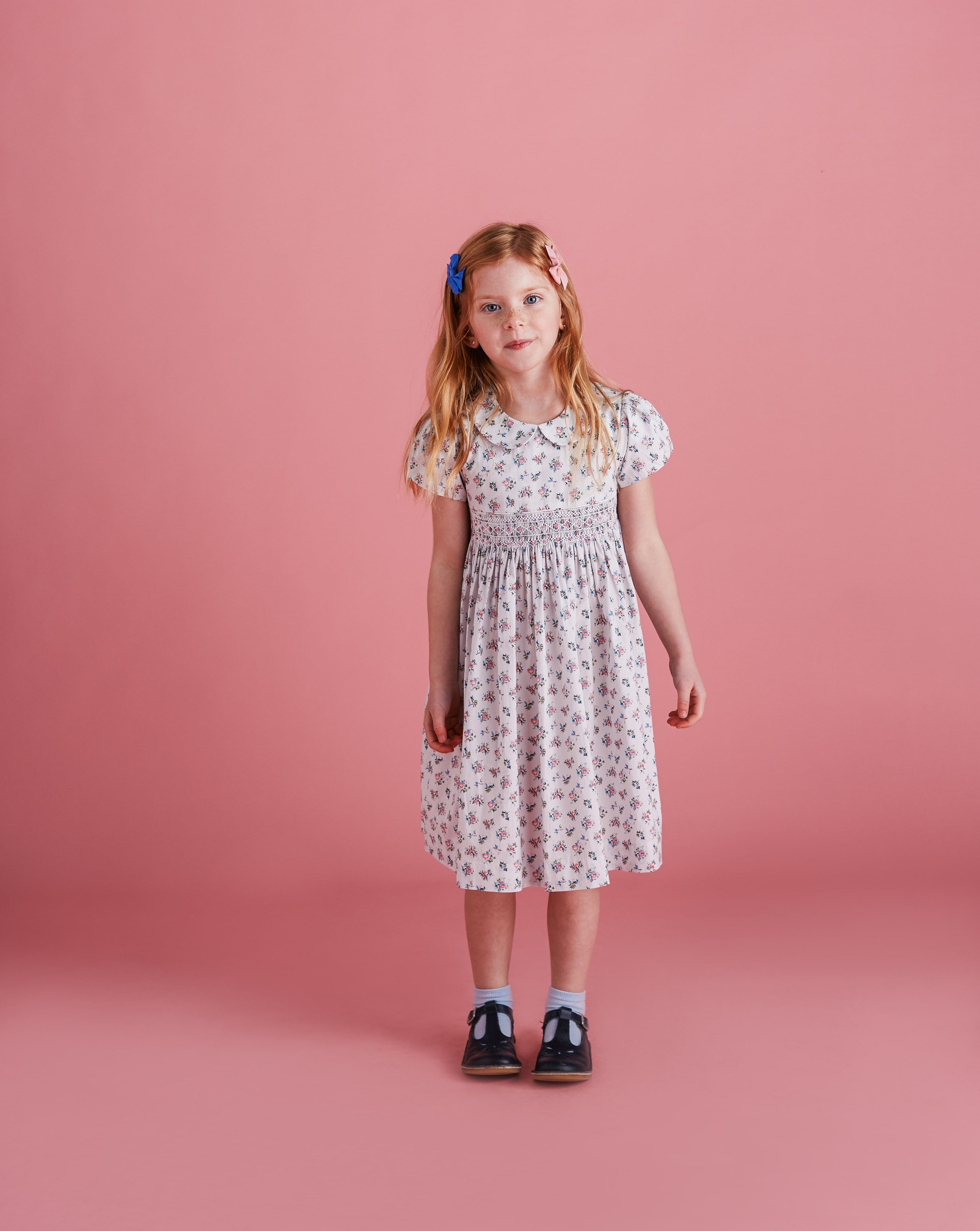 girl wearing smocked dress made from floral fabric