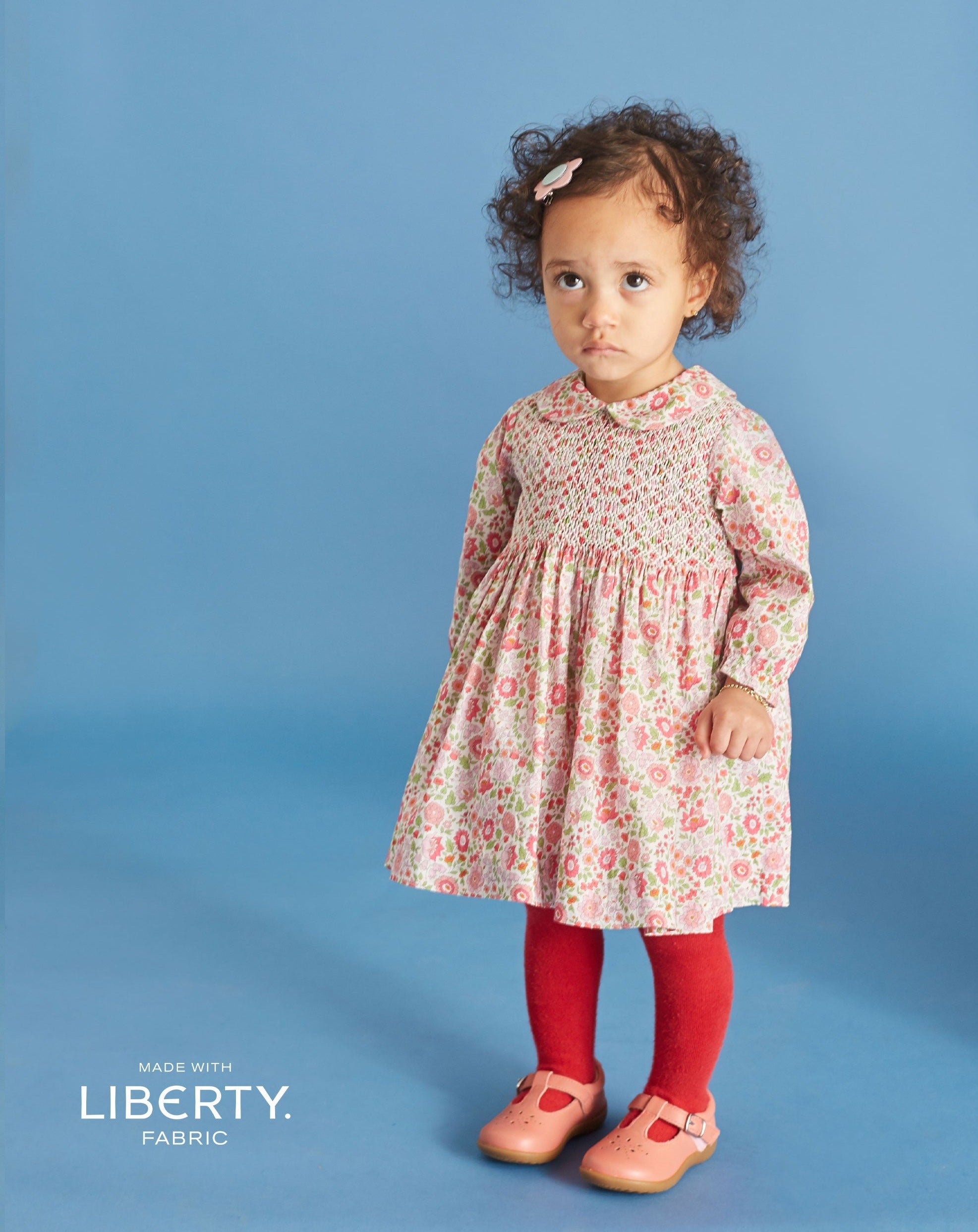 baby in Liberty print dress