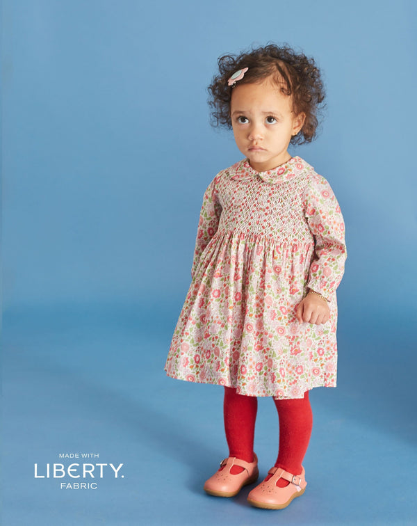 baby in Liberty print dress