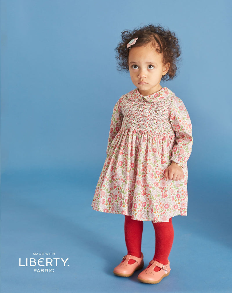baby in Liberty print dress