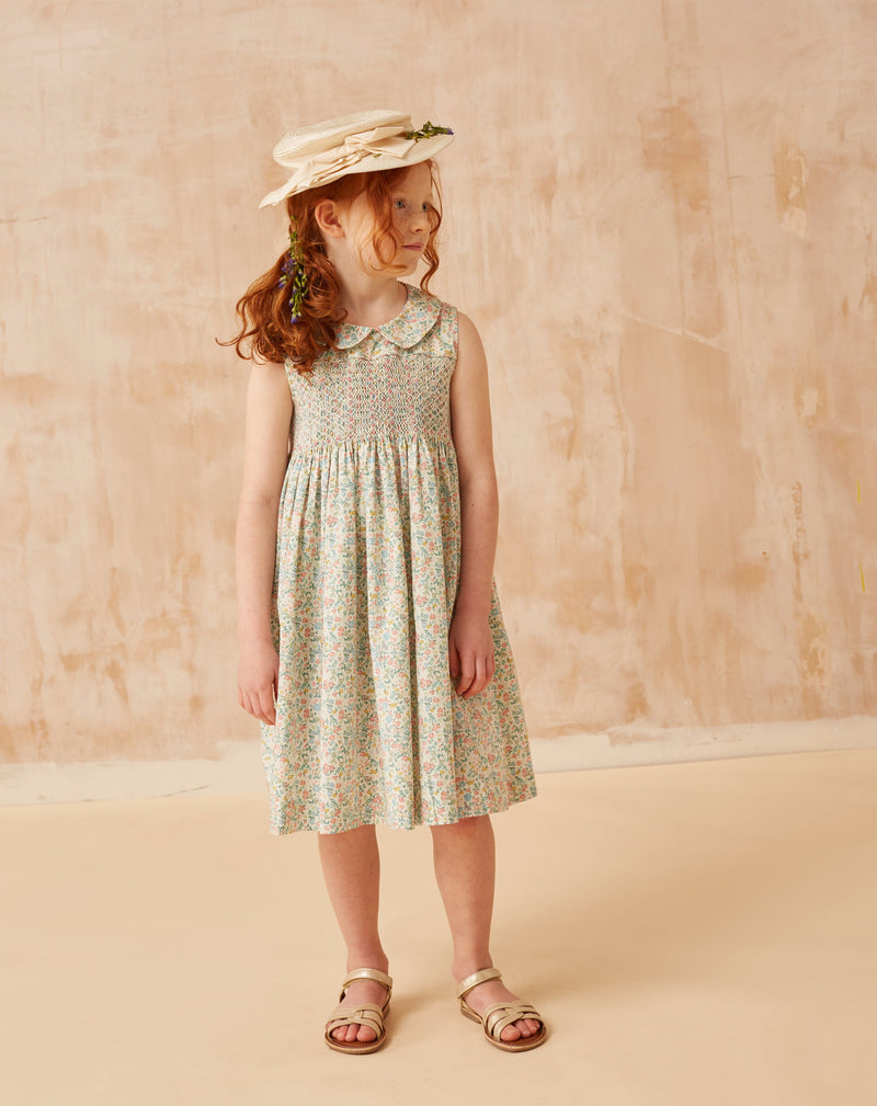 girl in summer dress with short sleeves and hand-smocking